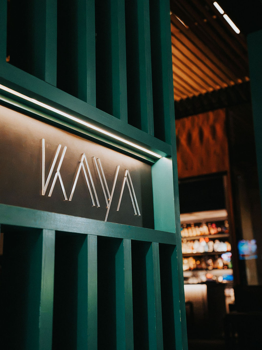 The KAYA sign through the green slats