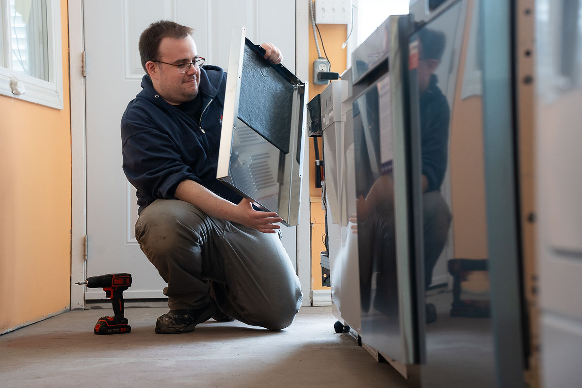 Al's Appliance technician servicing a refrigerator door in Kitchener Al's Appliance technician servicing a refrigerator door in Kitchener