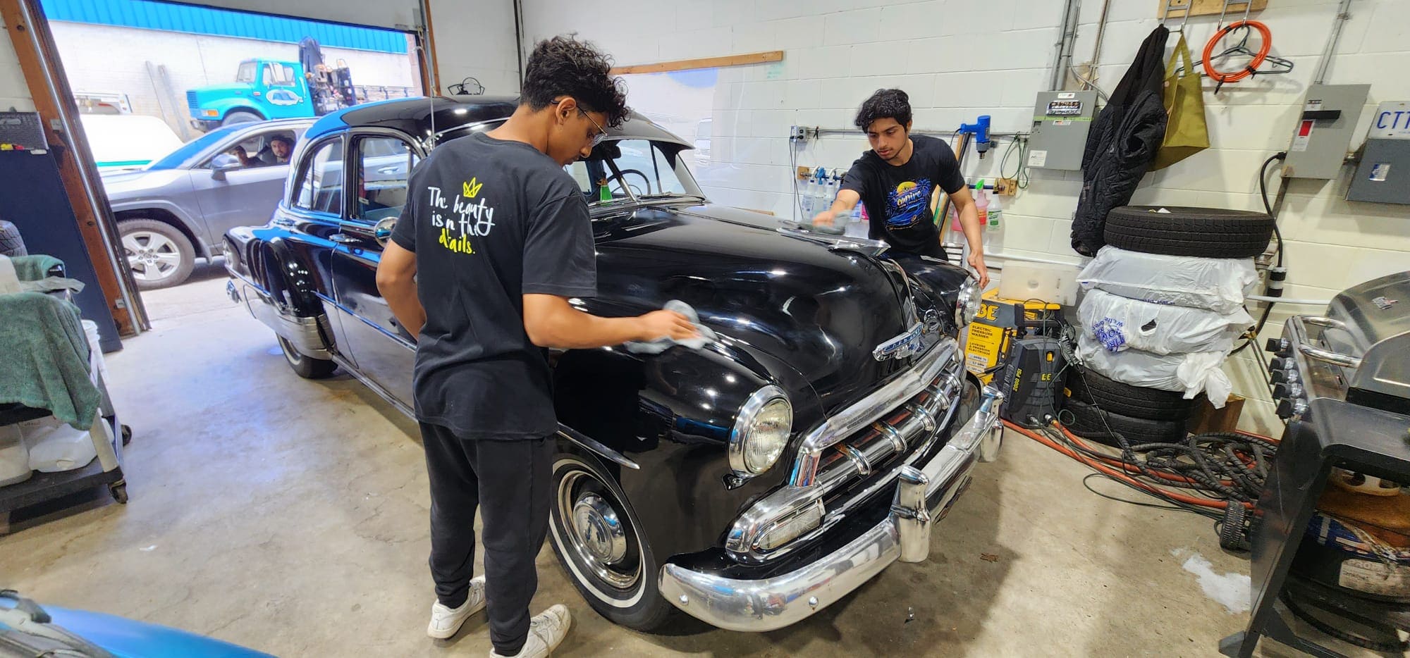 Student learning hands-on detailing techniques on a vehicle