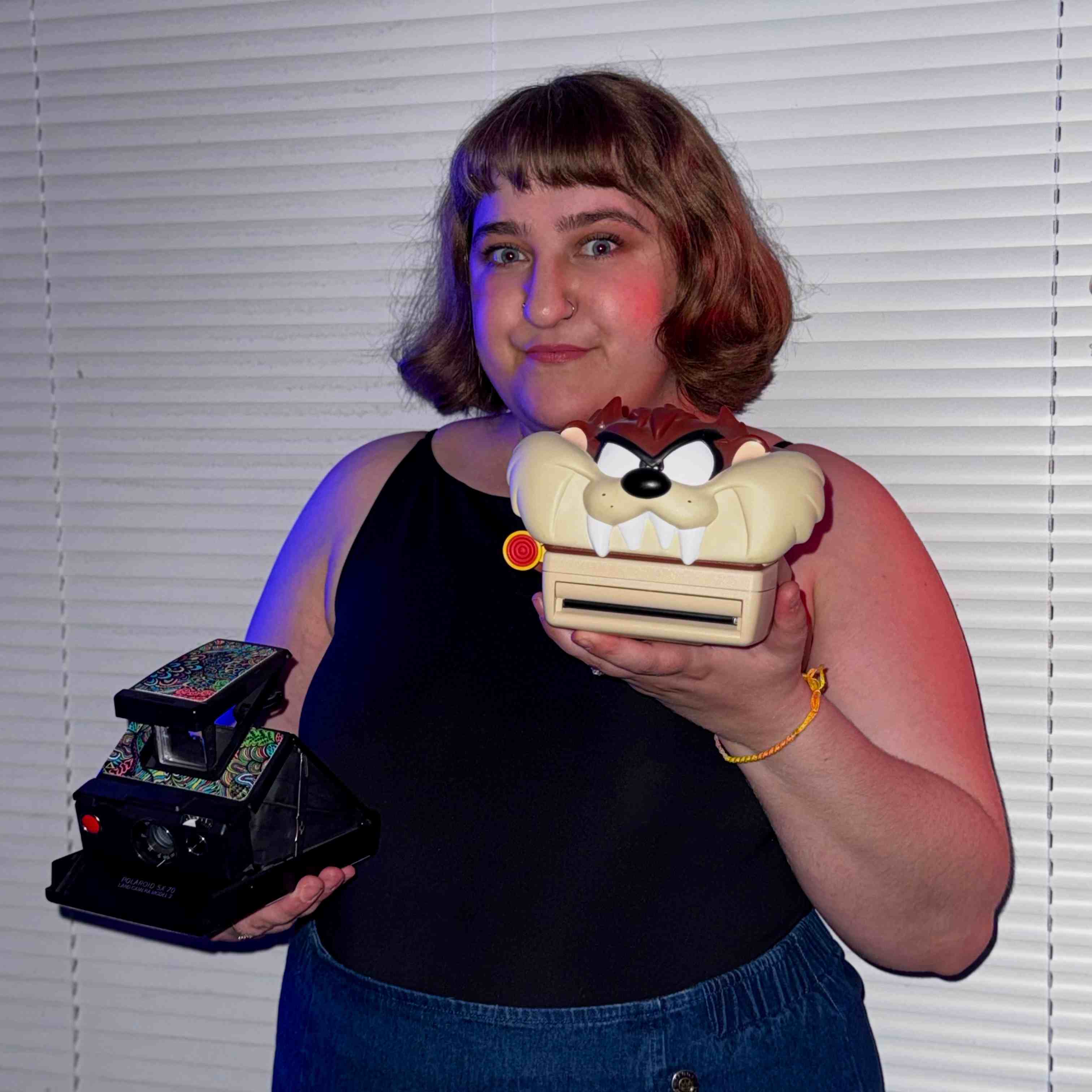 megan banting holding a tazmanian devil polaroid camera