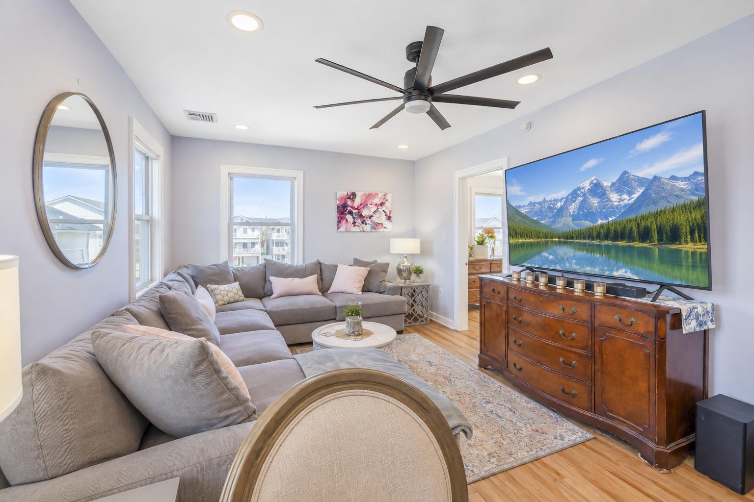 Bright upper living room with a large sectional