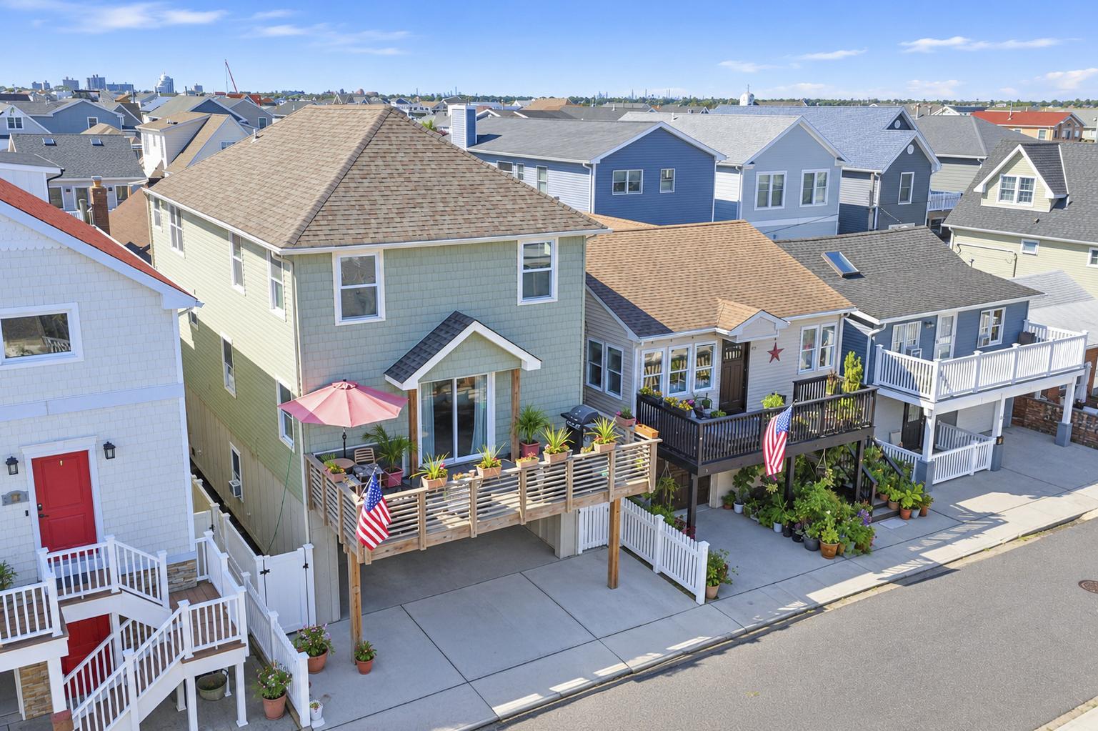 77 Nebraska Street today, with its coastal exterior, front deck and two-car driveway