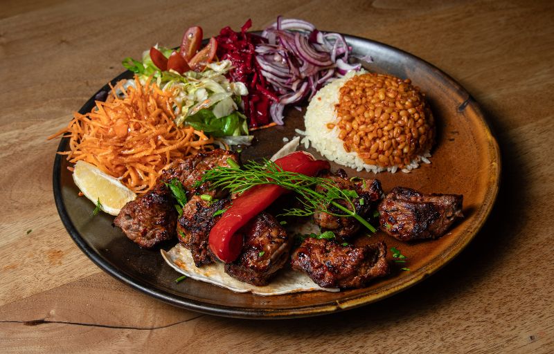 Lamb Shish kebab charcoal-grilled with peppers, rice and fresh salad at Mosaic Braintree