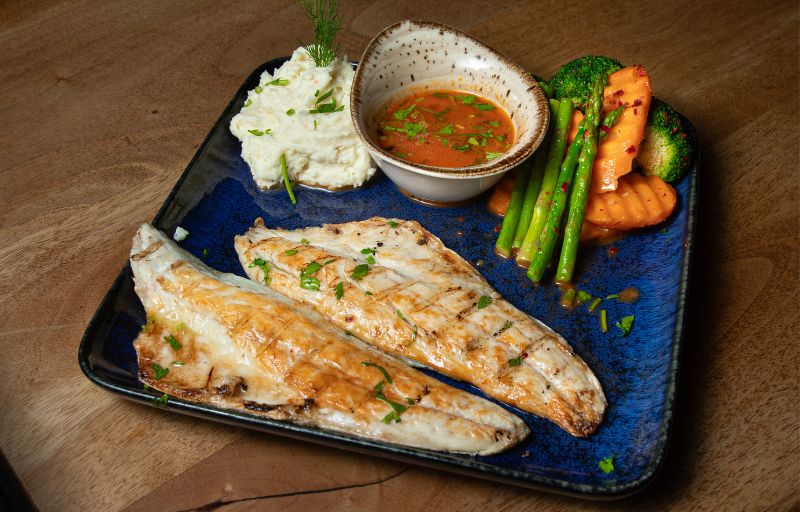 Grilled Sea Bass fillets with creamy mash and seasonal vegetables at Mosaic Braintree
