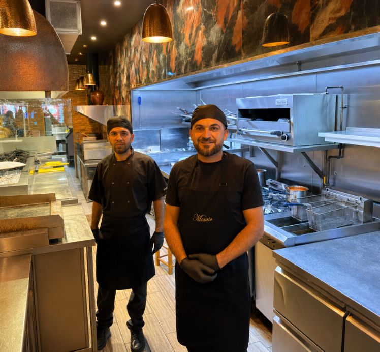 Mosaic Braintree chef grilling shish kebabs over charcoal