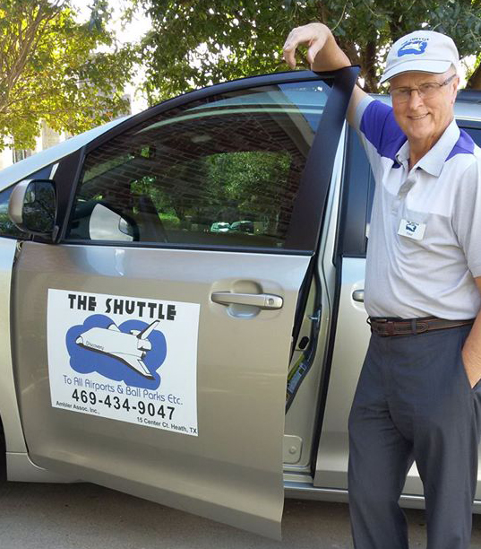 Owner and lead driver Peter Ambler standing beside The Shuttle van