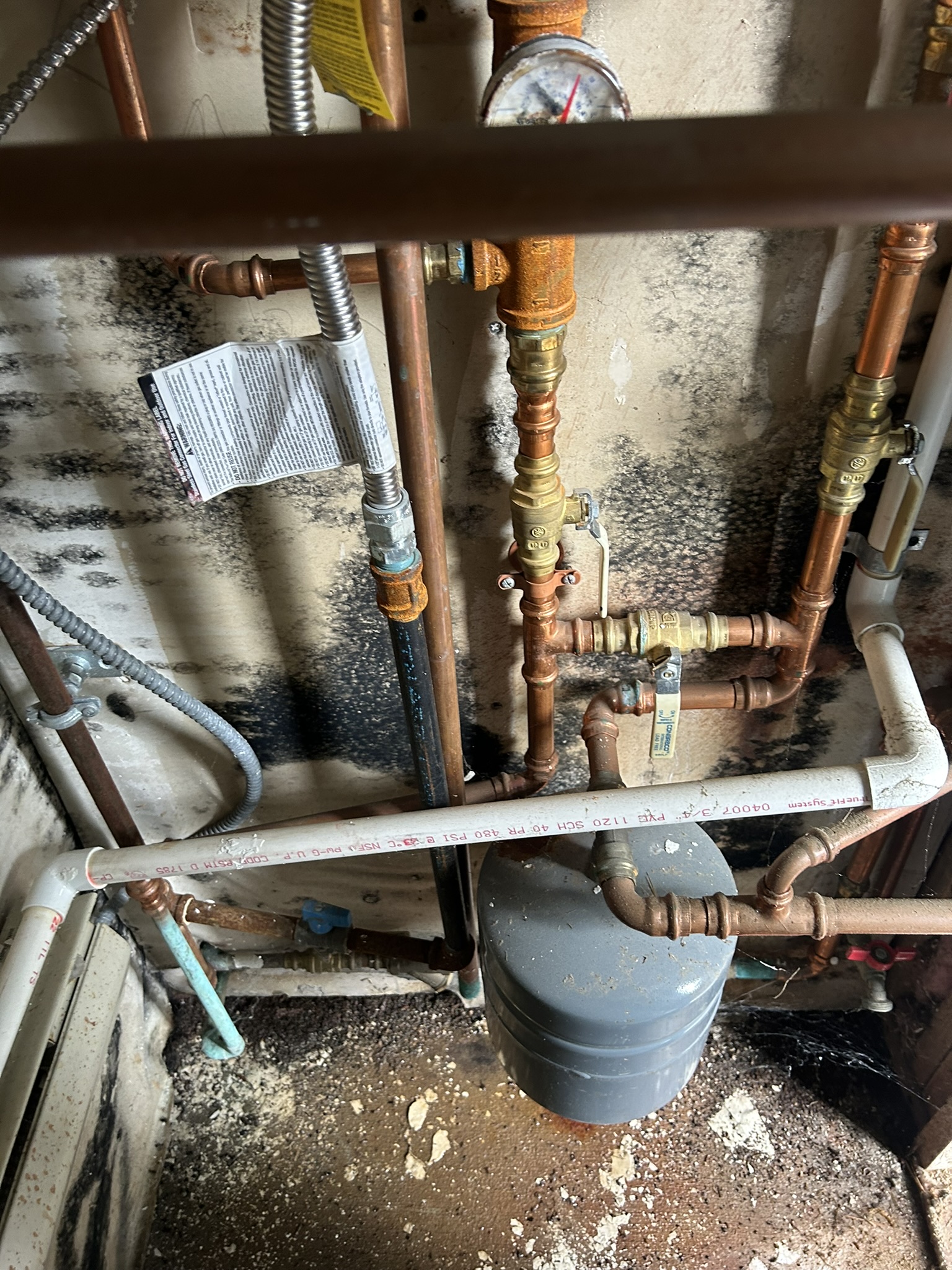 Nashua utility room before: corner by heating pipes