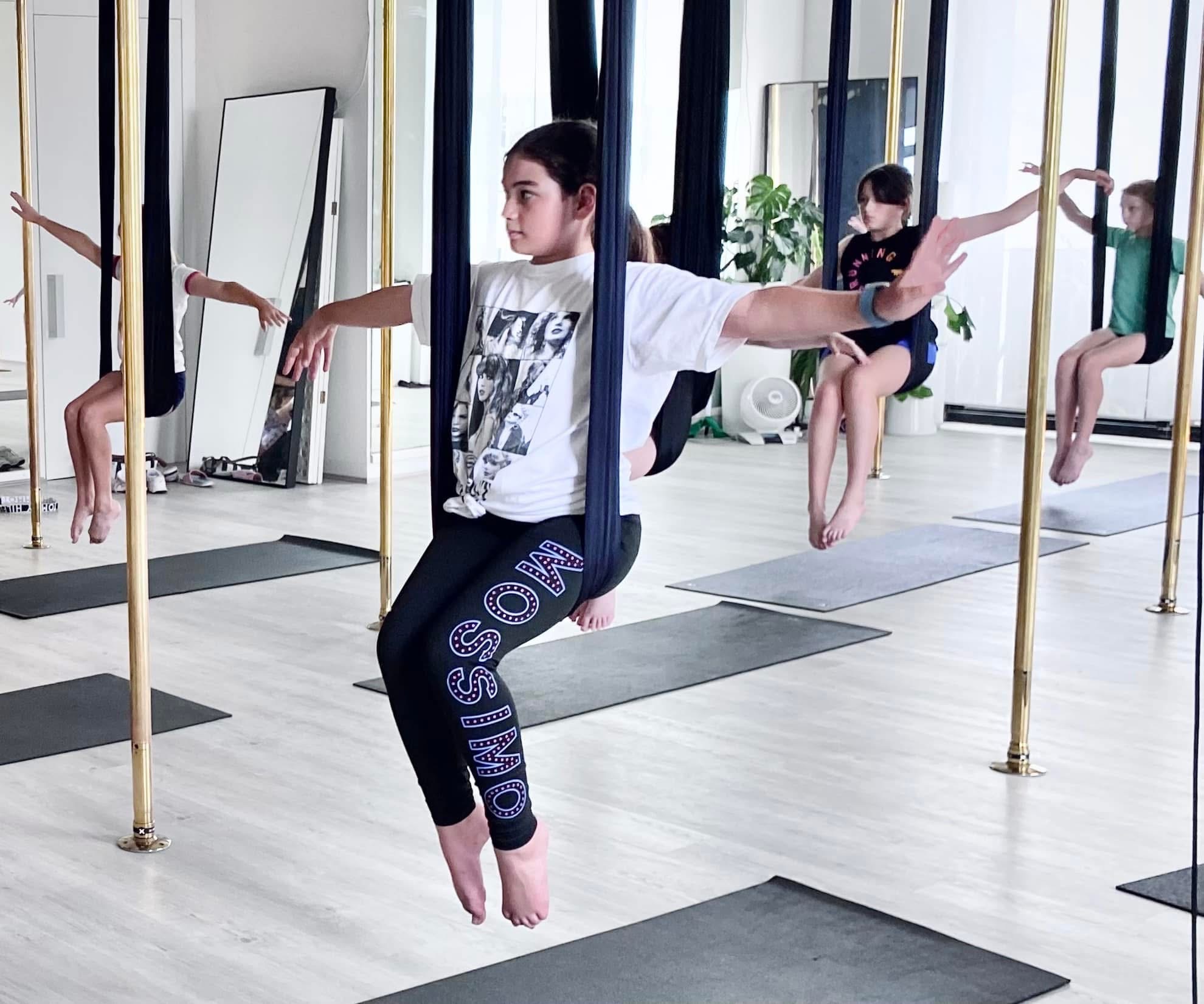 Kids taking part in an Aerial Fit Kids class at Achieve Pole Studio