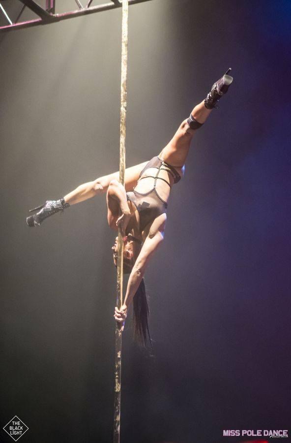 Andrea Ryff, founder of Achieve Pole Studio and two-time World Pole Champion, in a split on the pole