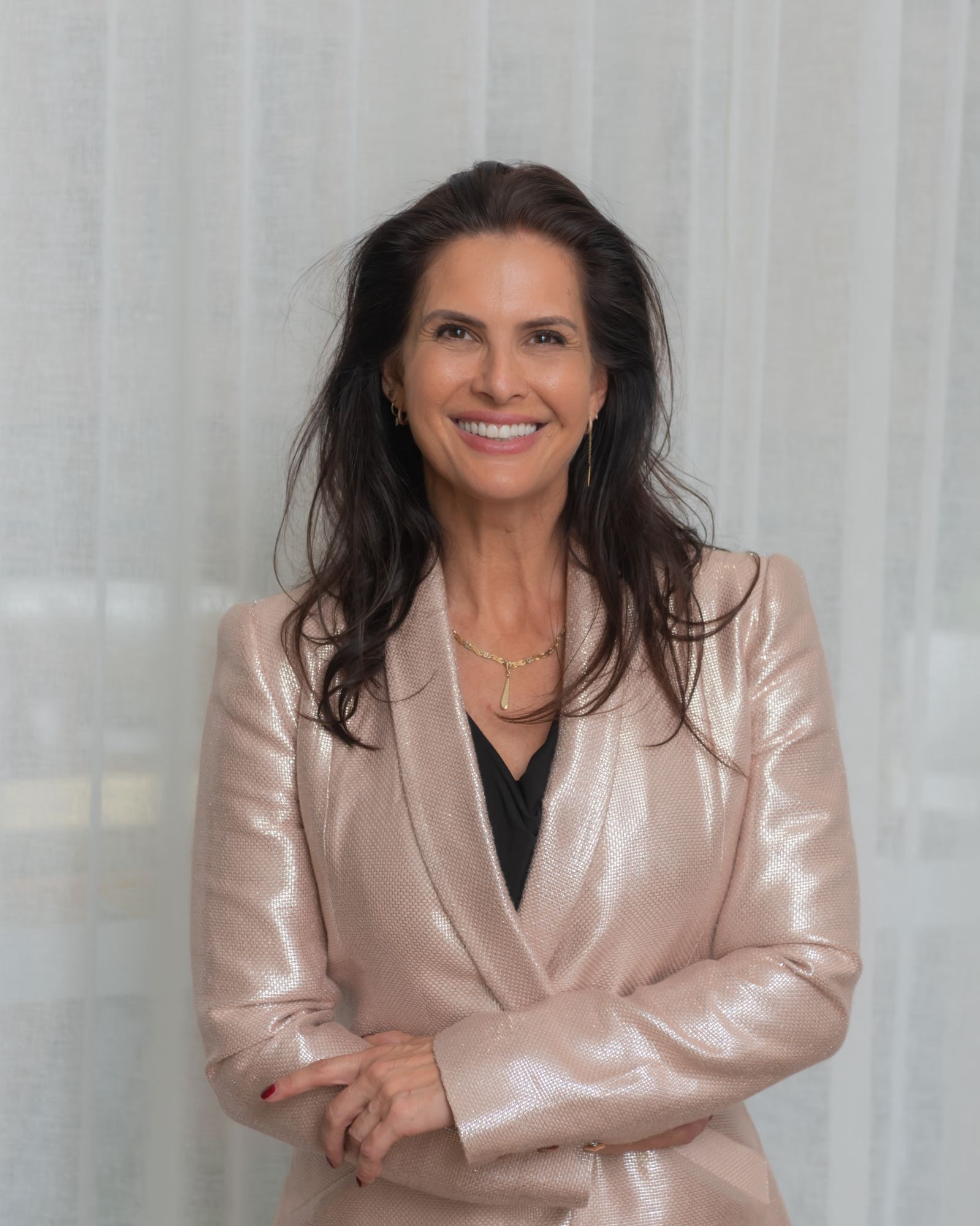 Andrea Ryff smiling in a blush blazer