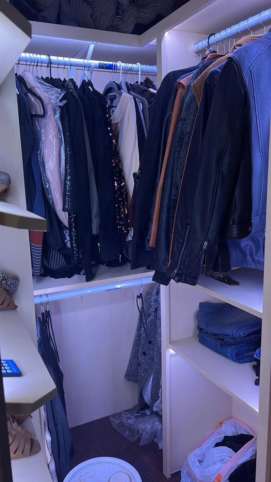 Finished walk-in closet fully stocked with hanging clothes and storage