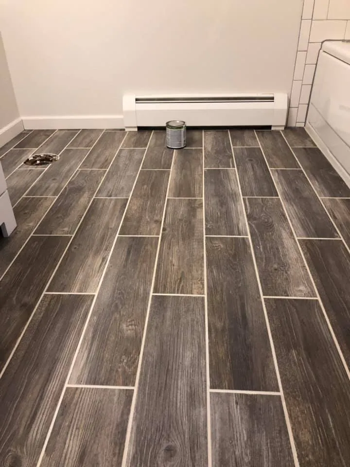 Finished wood-look tile floor in a room with a baseboard heater