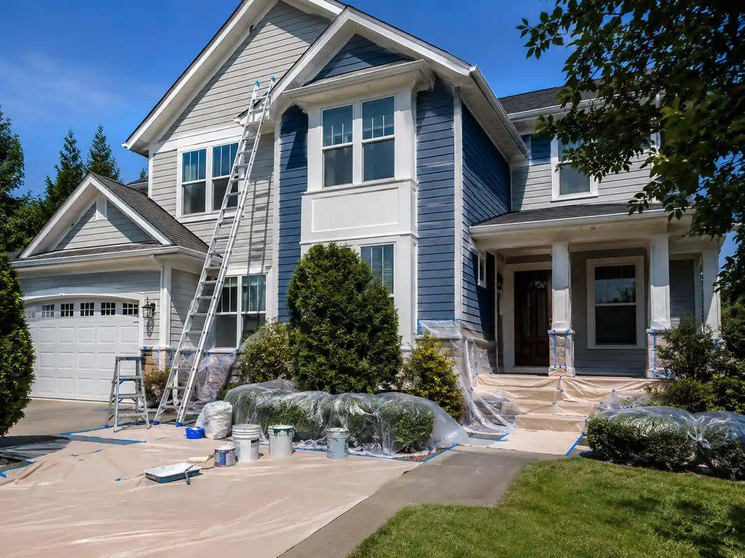Exterior painting services underway on a two-story residential property