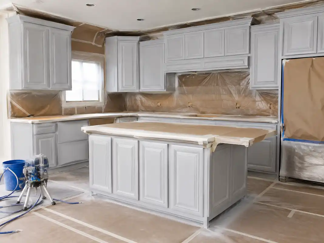Kitchen cabinetry masked and protected part-way through an interior repaint