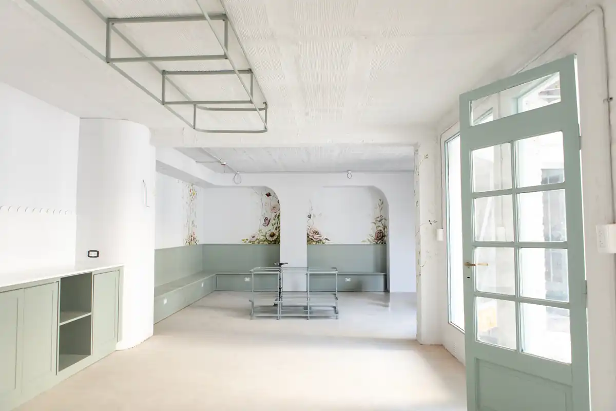 Interior prepared for painting with scaffolding, a glazed door and fitted cabinetry