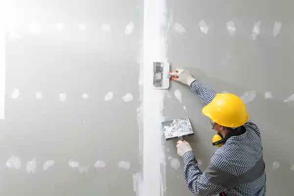 Interior wall repair being finished before painting