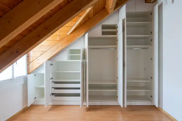 Built-in storage fitted under a timber-beamed ceiling