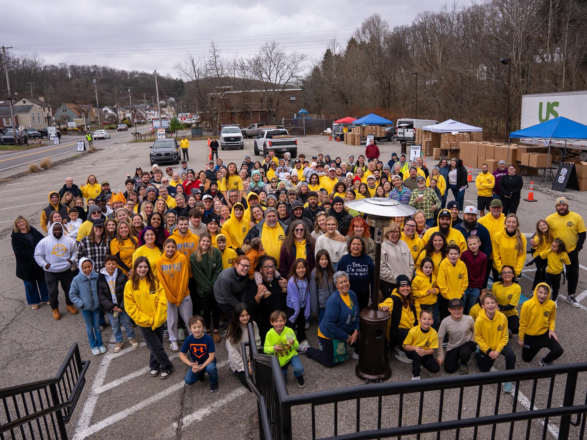 The 2025 YINZgiving volunteer group photo in the Dive Bar parking lot