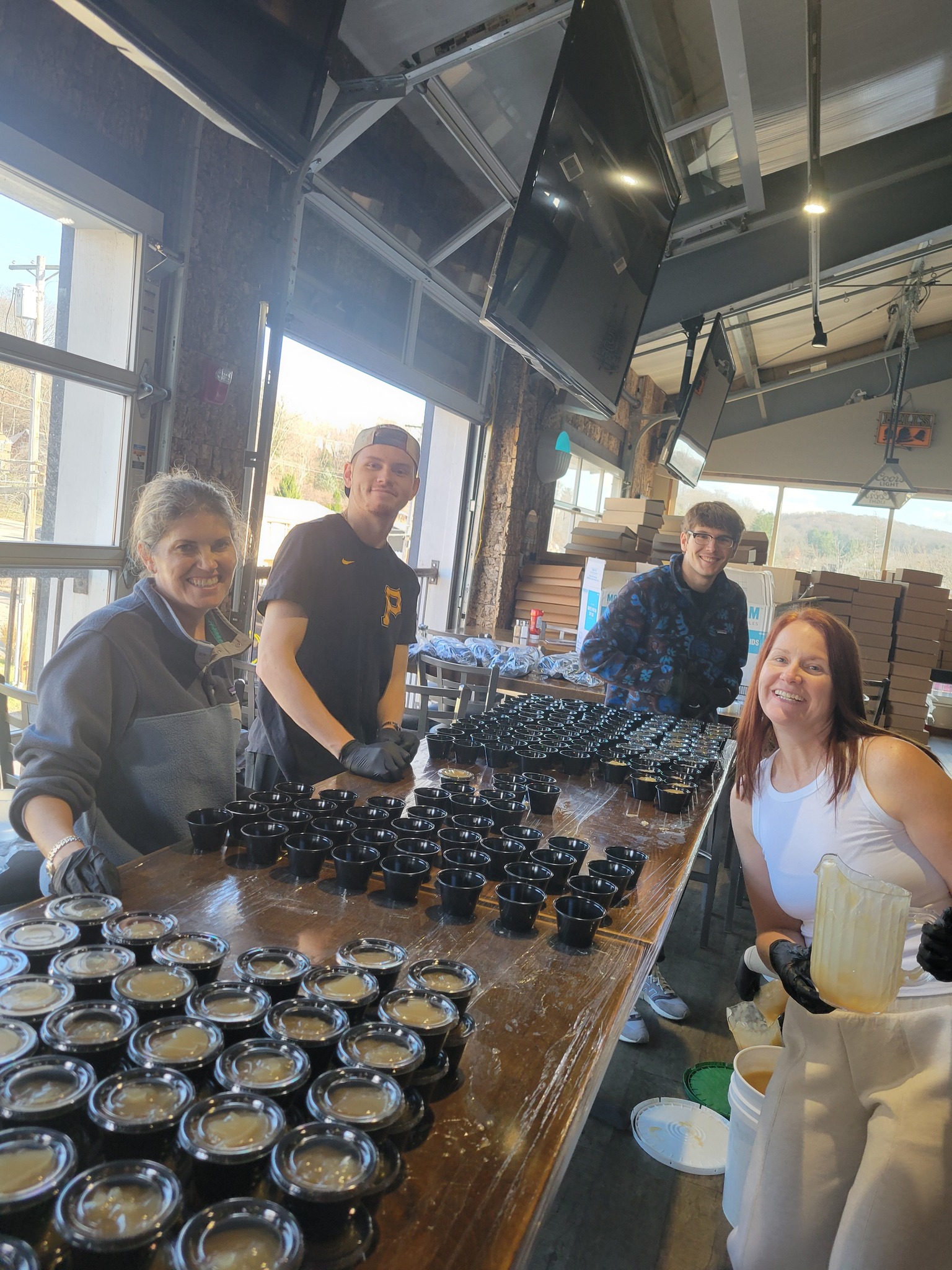 Volunteers portioning hundreds of gravy cups on prep day