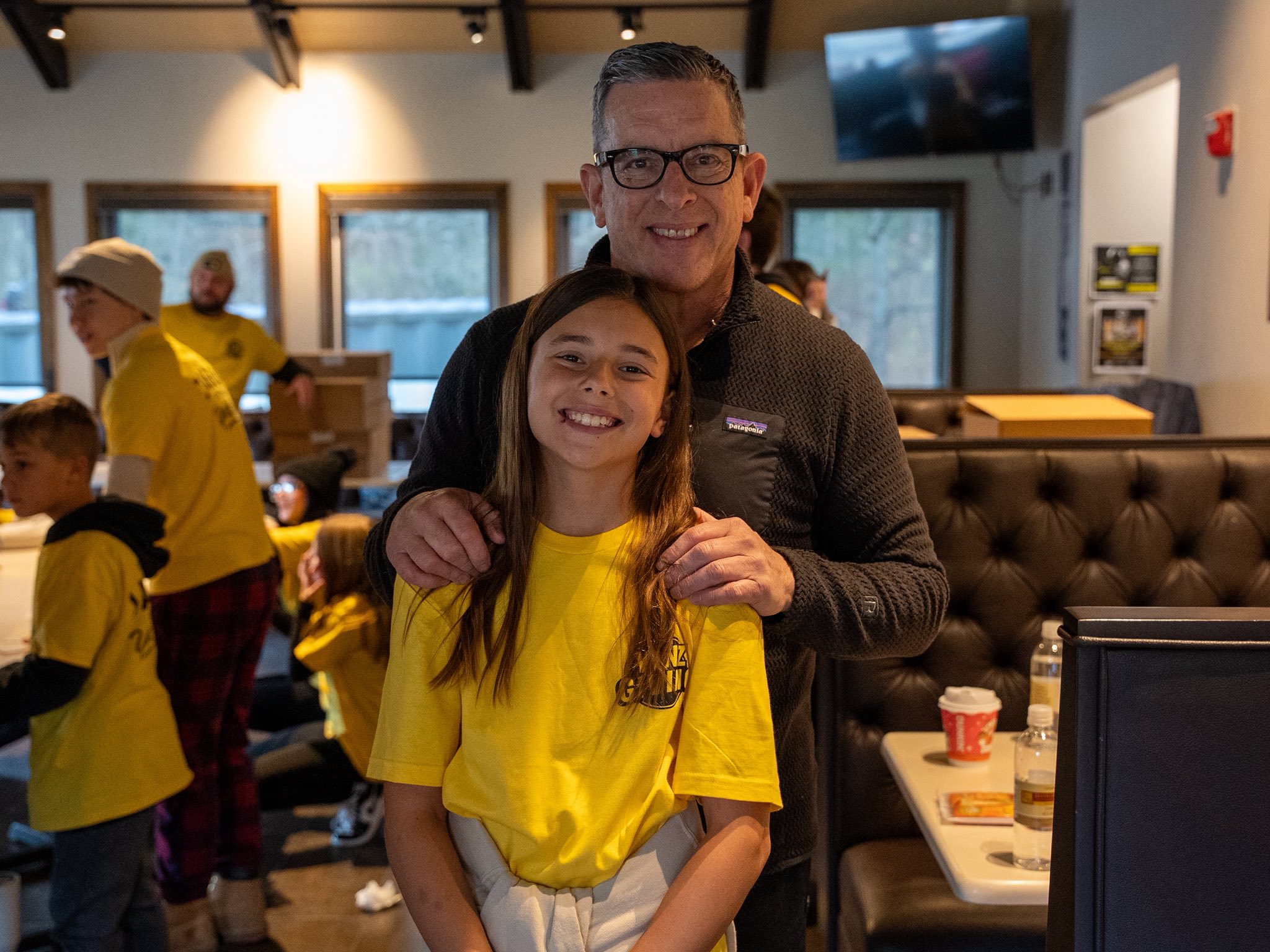 A father and daughter working together with gloves on prep day