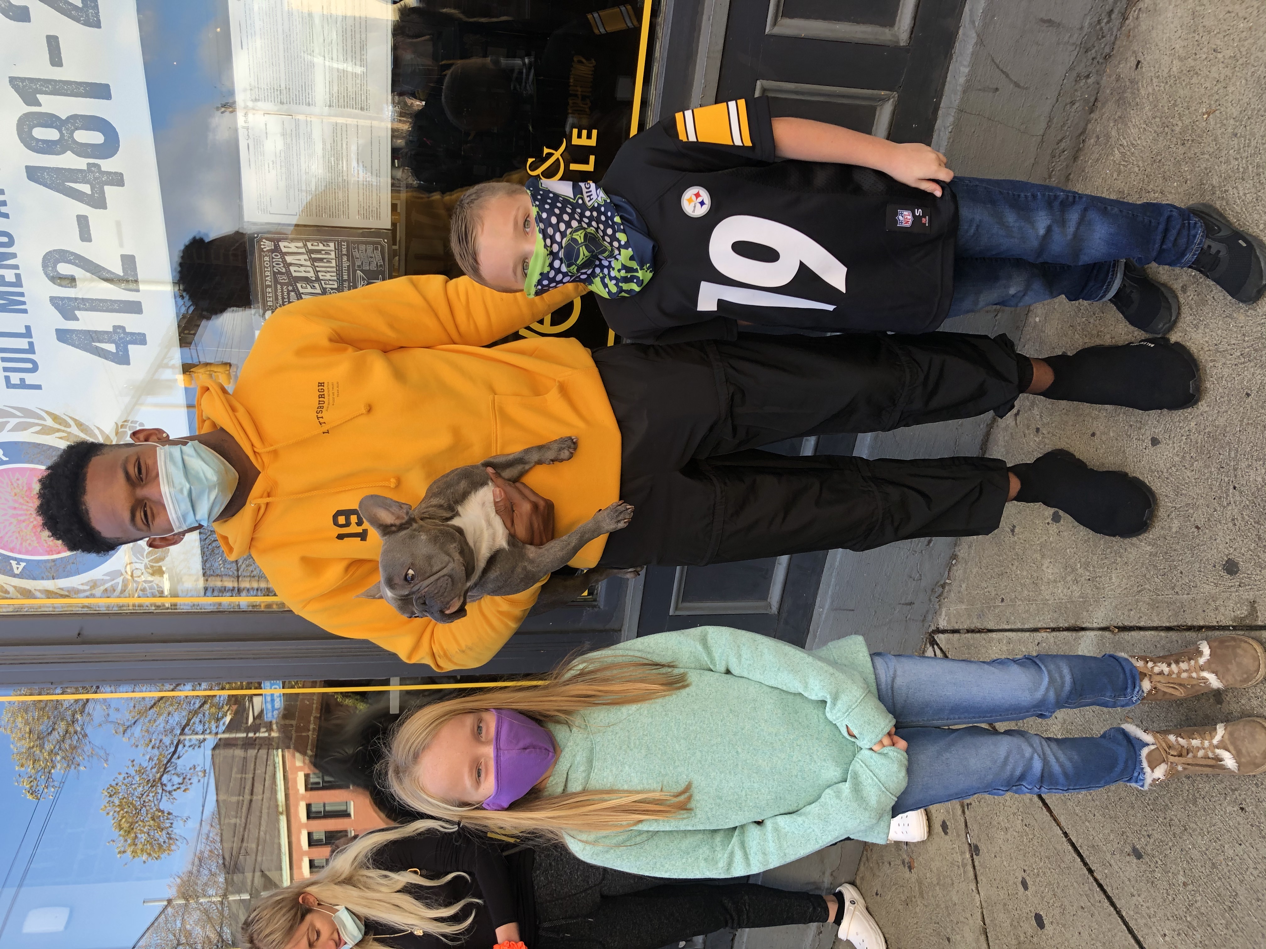 JuJu Smith-Schuster with his dog and two young volunteers at YINZgiving