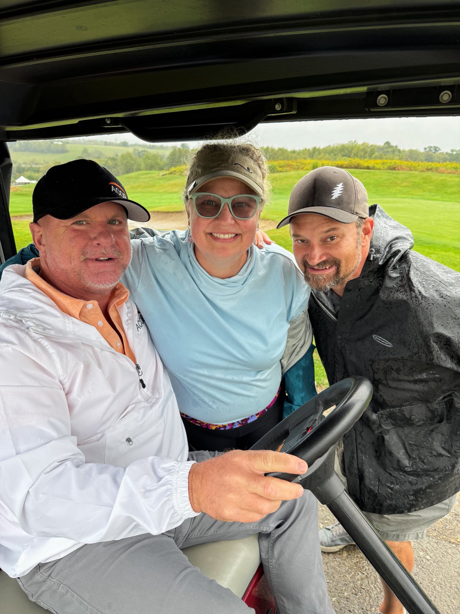 Rachel Maga and two volunteers in a golf cart at the 2025 YINZgiving Golf Outing