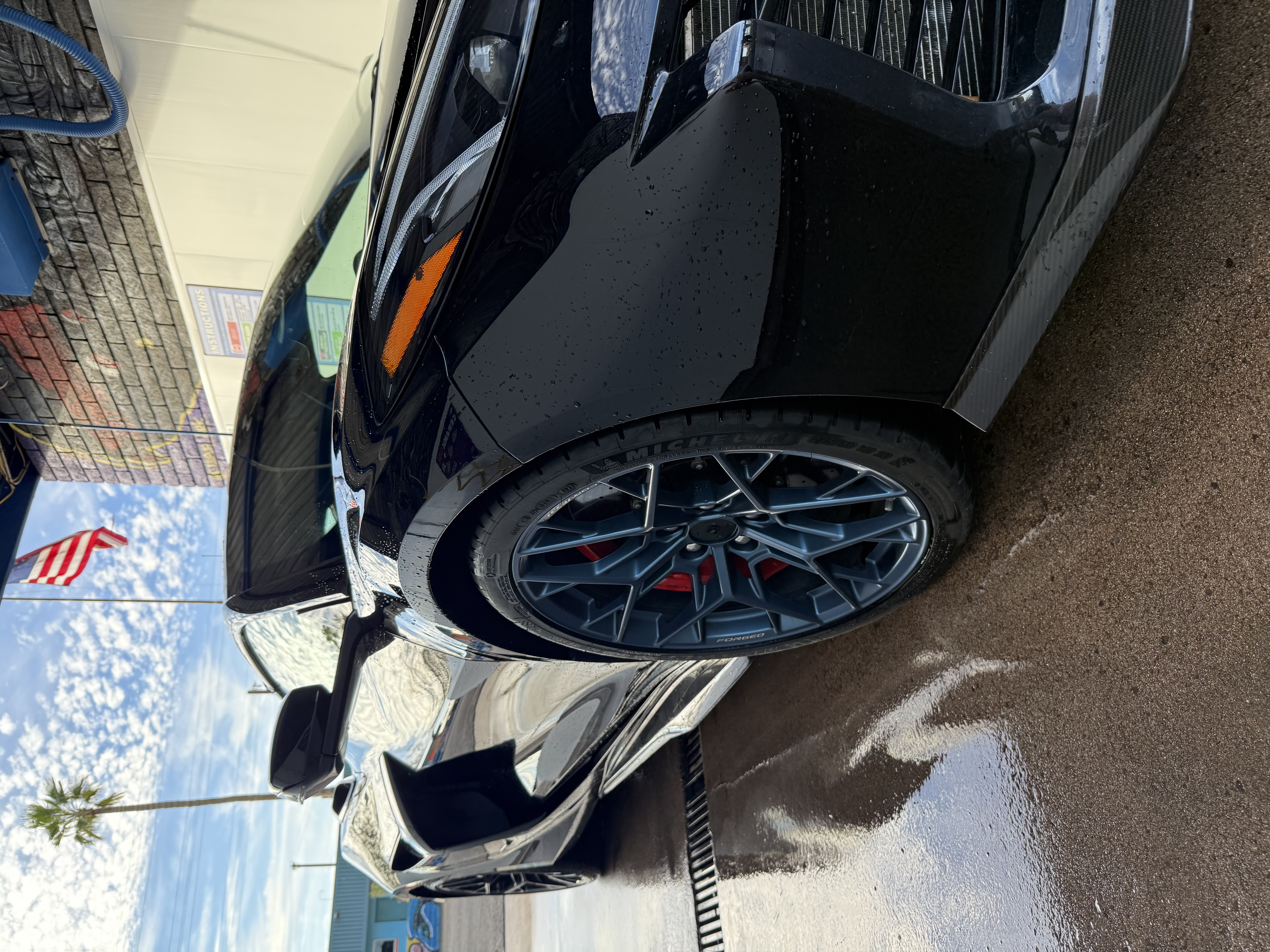 Blue aluminum Corvette wheels being washed at Bobby E's