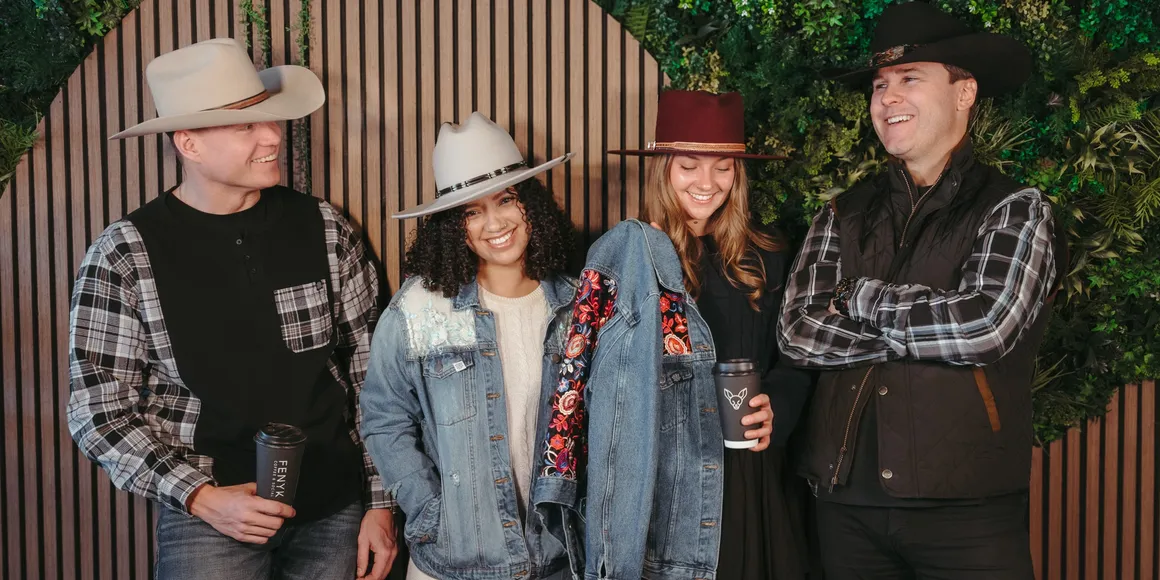 Group of guests wearing custom hats from Ace High Hat Bar