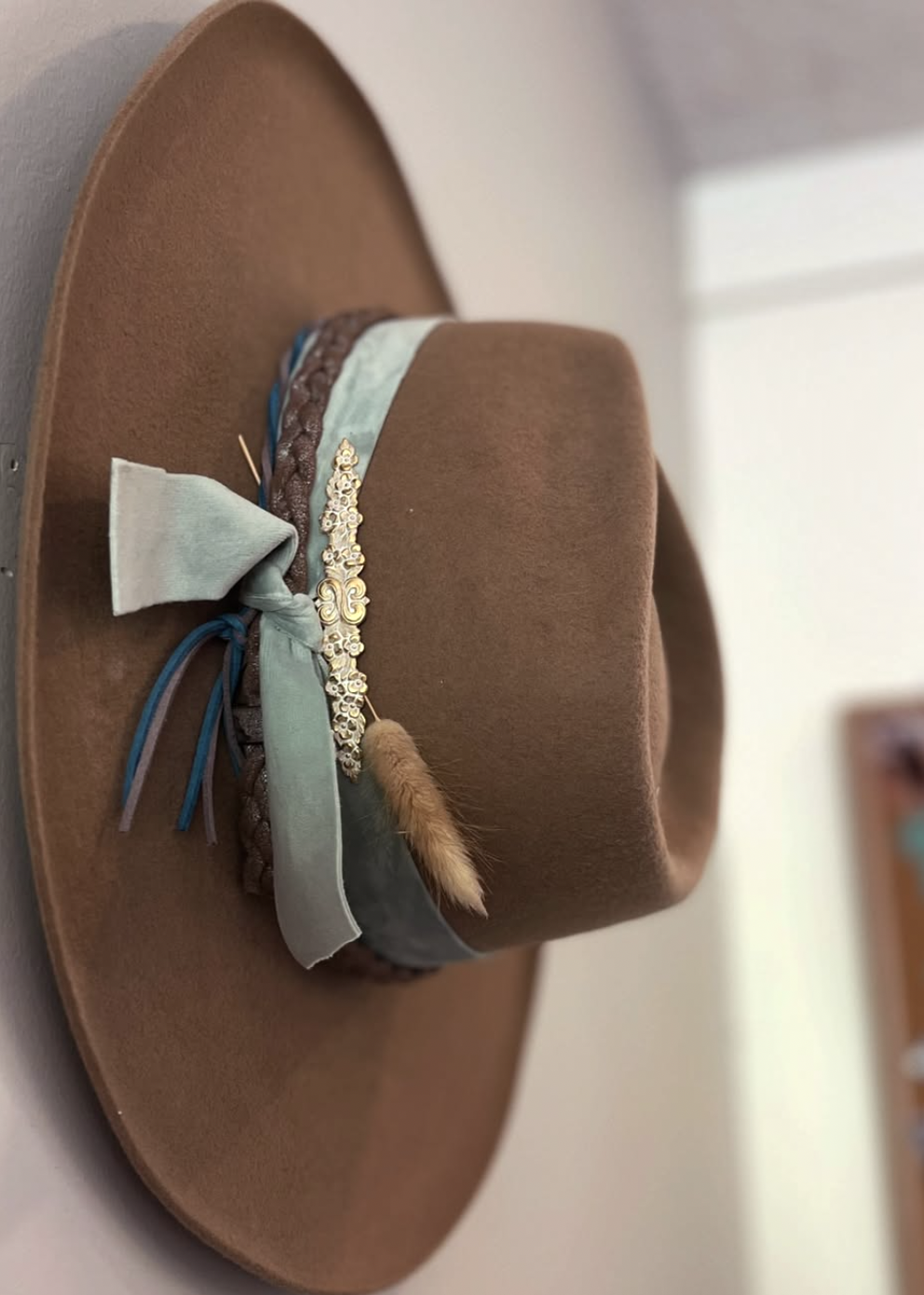 Brown felt hat with sage ribbon and feather, hand-shaped in Calgary