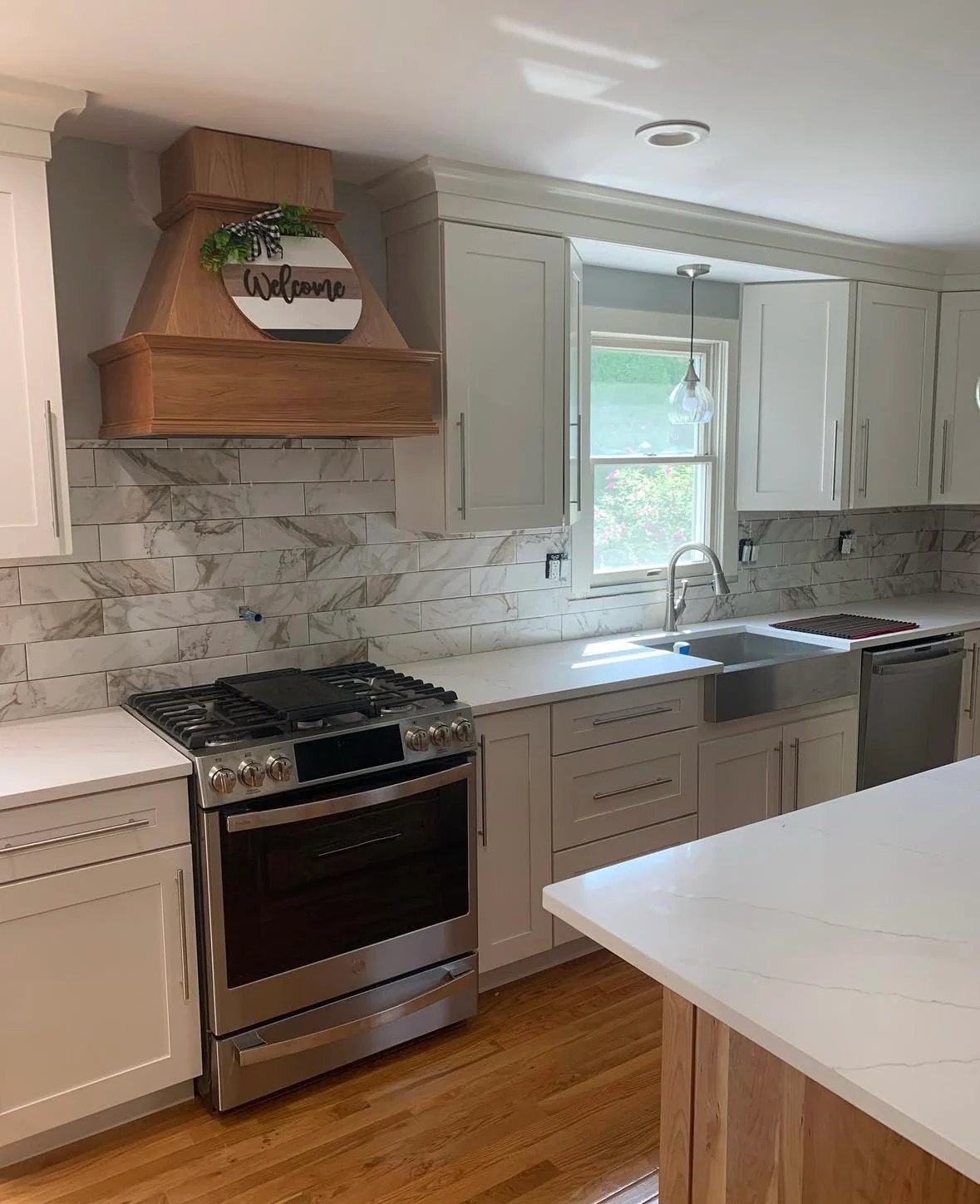 Trevose kitchen remodel showing cooking area with wood-tone hood and cabinetry