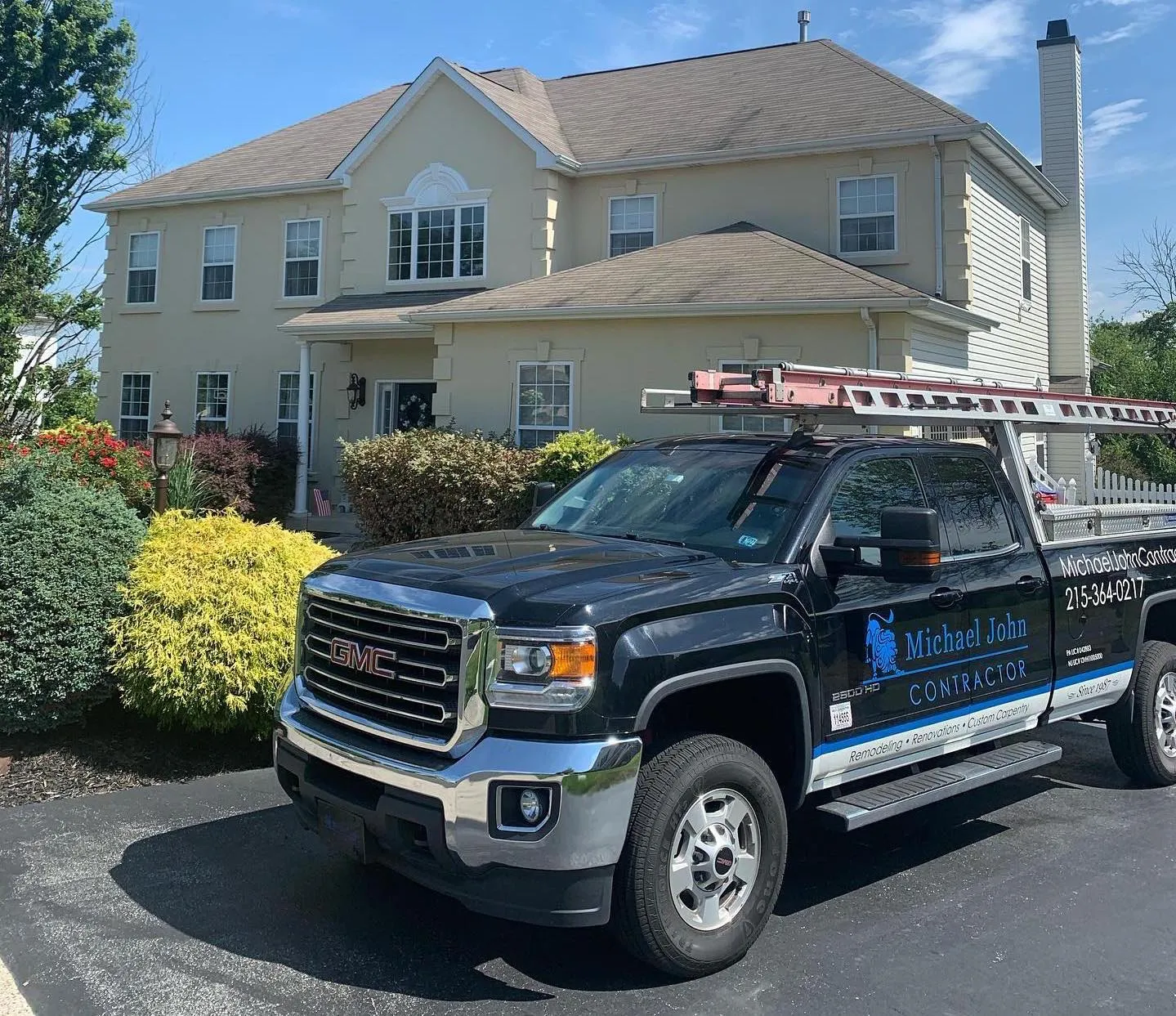 Michael John Contractors branded work truck at a residential property