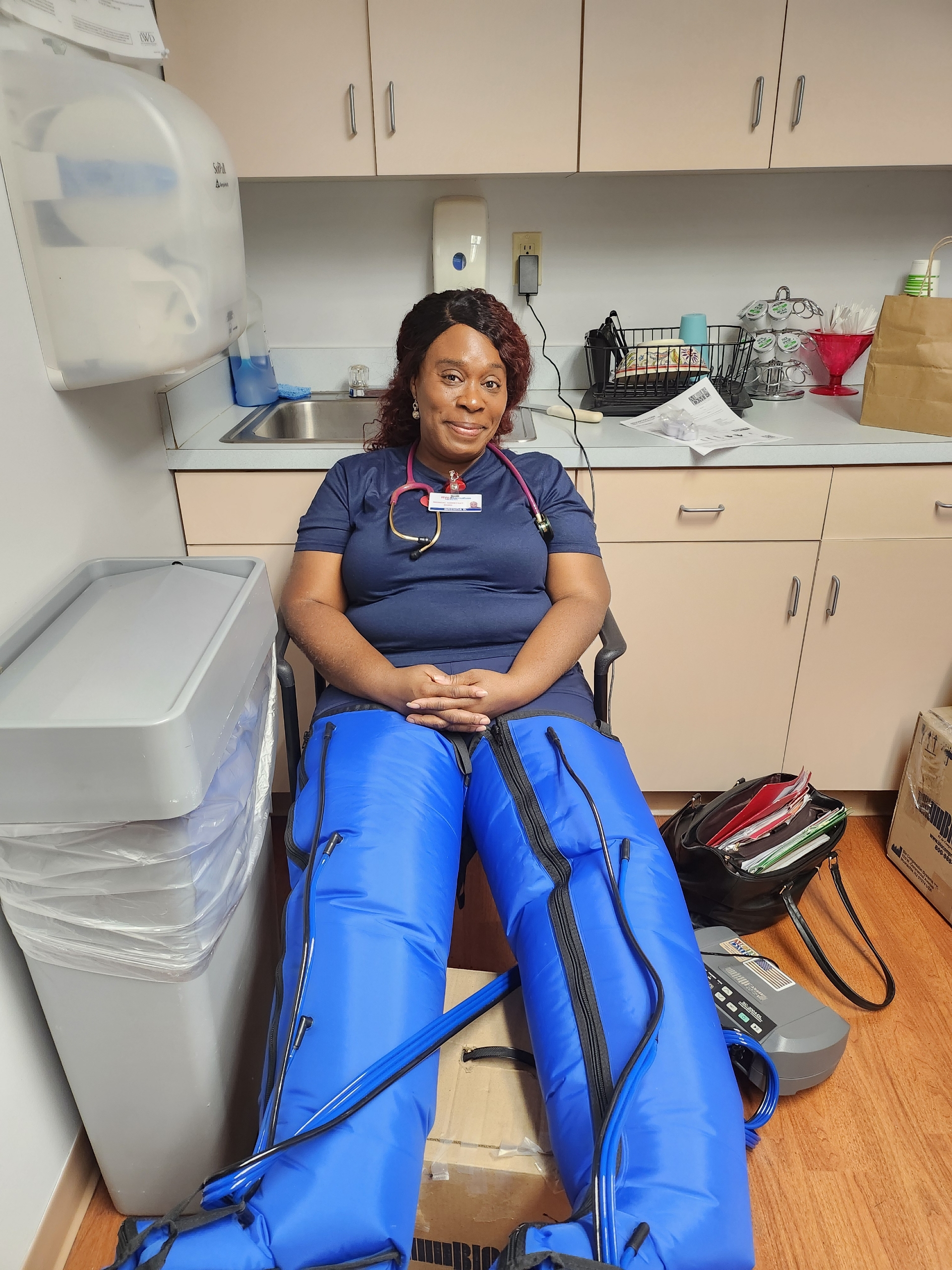 Woman using lymphedema pump with inflated legs in a clinical setting Woman using lymphedema pump with inflated legs in a clinical setting