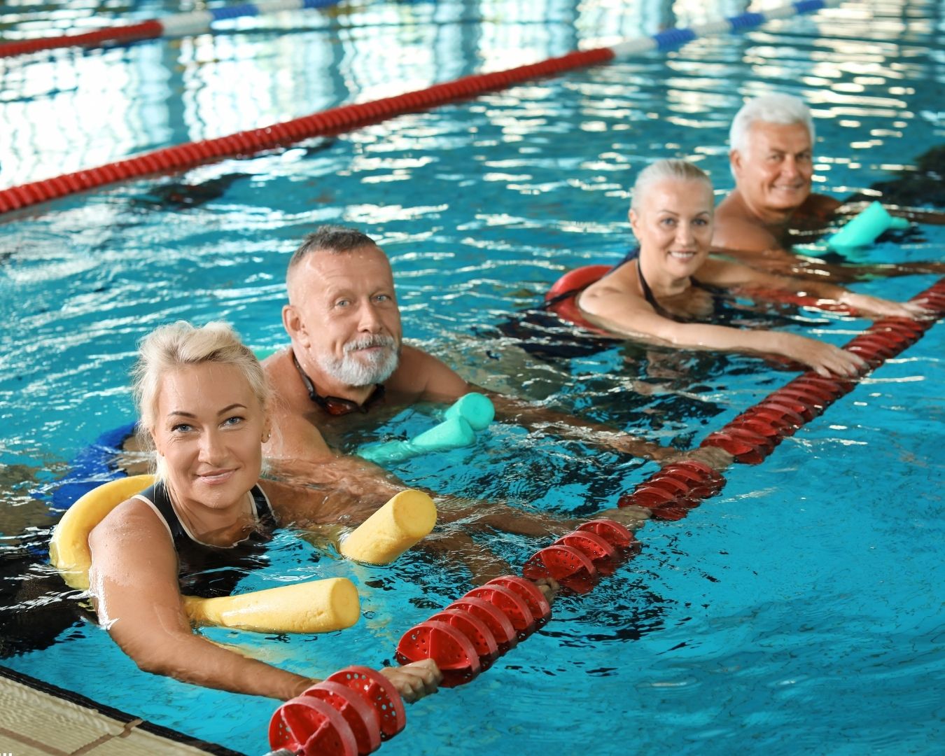 Patient performing aquatic therapy exercises in a pool for lymphedema water therapy and swelling management