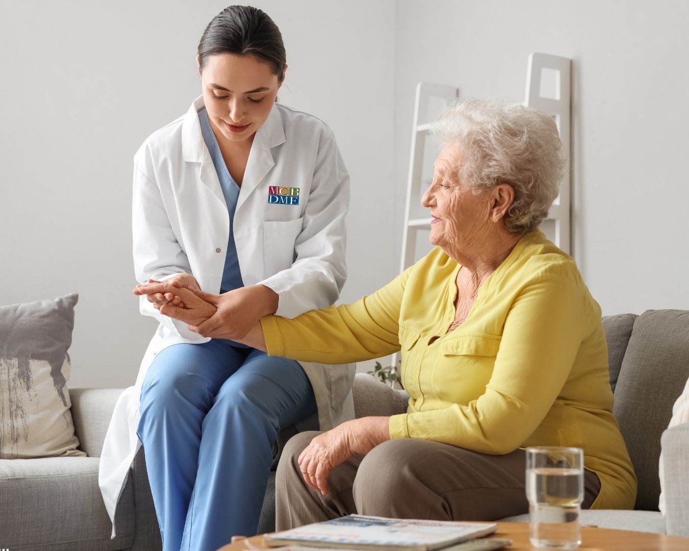 Patient receiving compression garment fitting from a physical therapist as part of lymphedema treatment