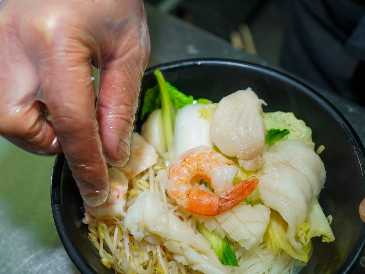Seafood rice noodle soup with prawns, squid and fish cake