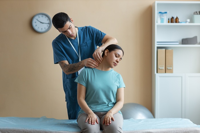 Chiropractor performing mid-back spinal adjustment on patient in Asheville NC
