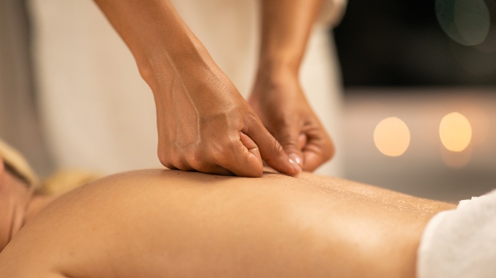 Patient relaxing on massage therapy table during treatment session in Asheville NC