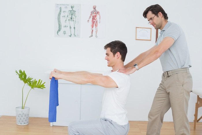 Chiropractor performing posture analysis and assessment for posture correction in Asheville NC