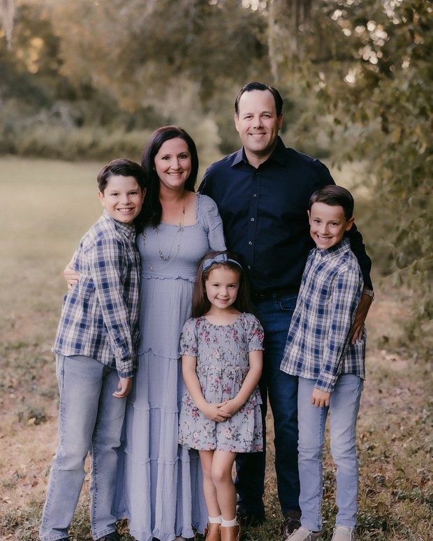 A family of five outdoors at golden hour