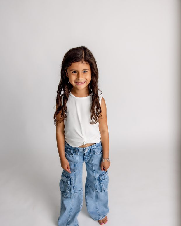 A young girl photographed on a simple backdrop