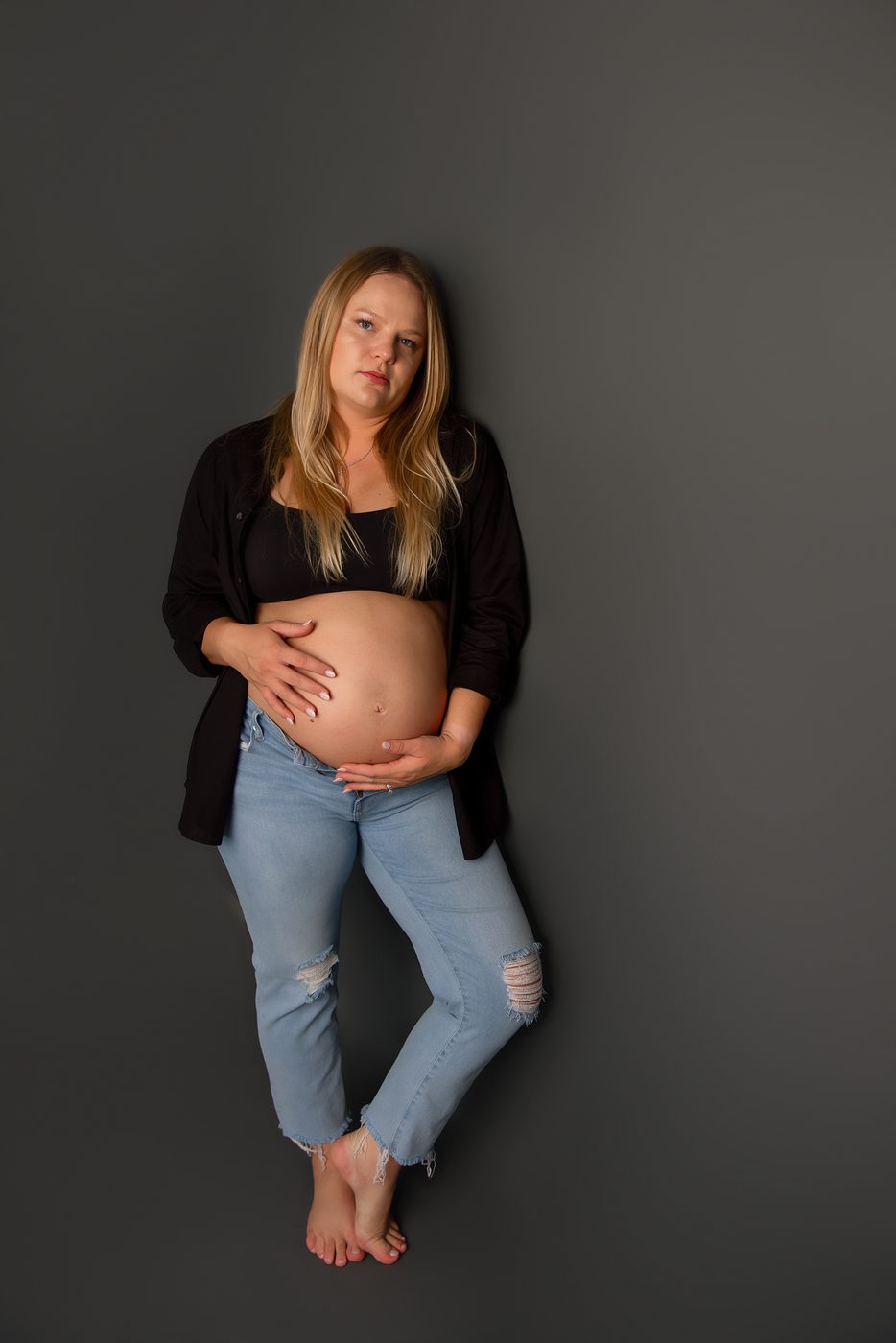 Expecting mother in a relaxed studio maternity portrait