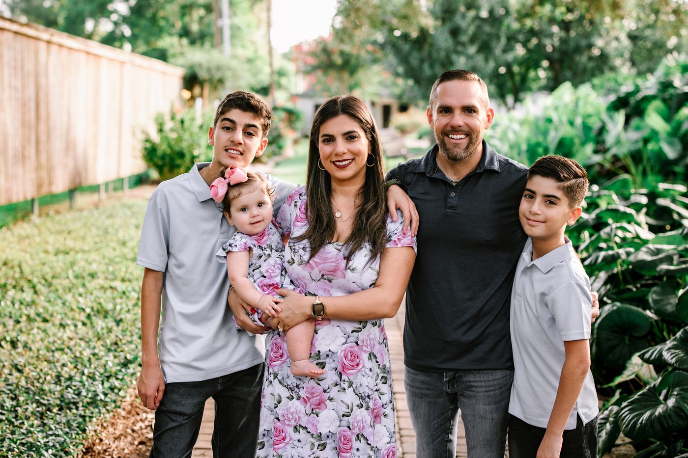 Family of five outdoors among the greenery