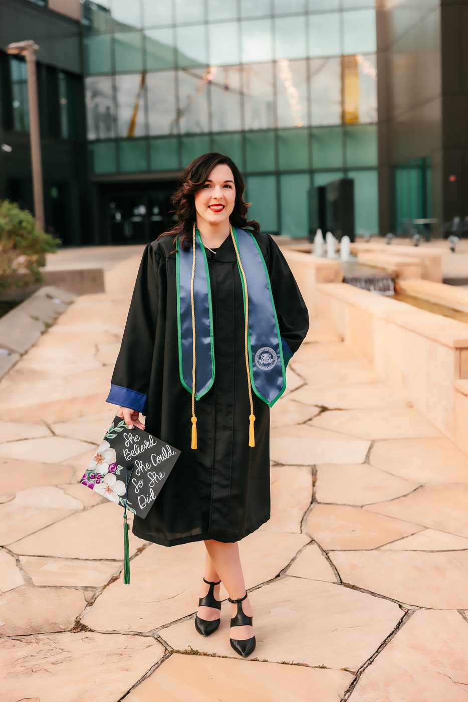 Graduation portrait in cap and gown on campus