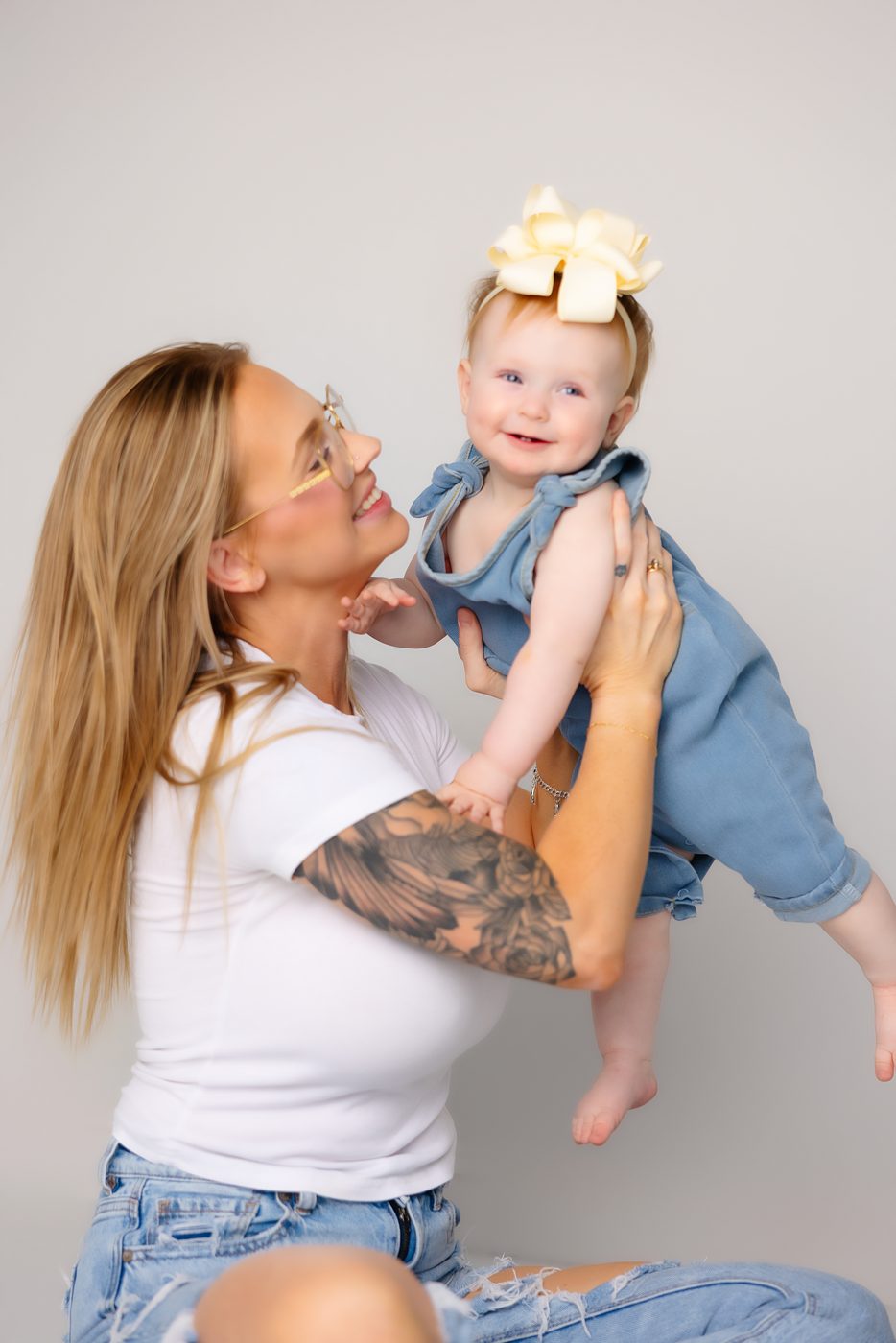 Mother lifting her one-year-old in the studio