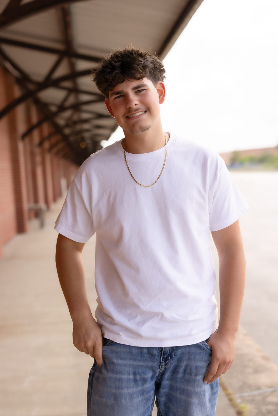 Senior portrait session under a covered walkway