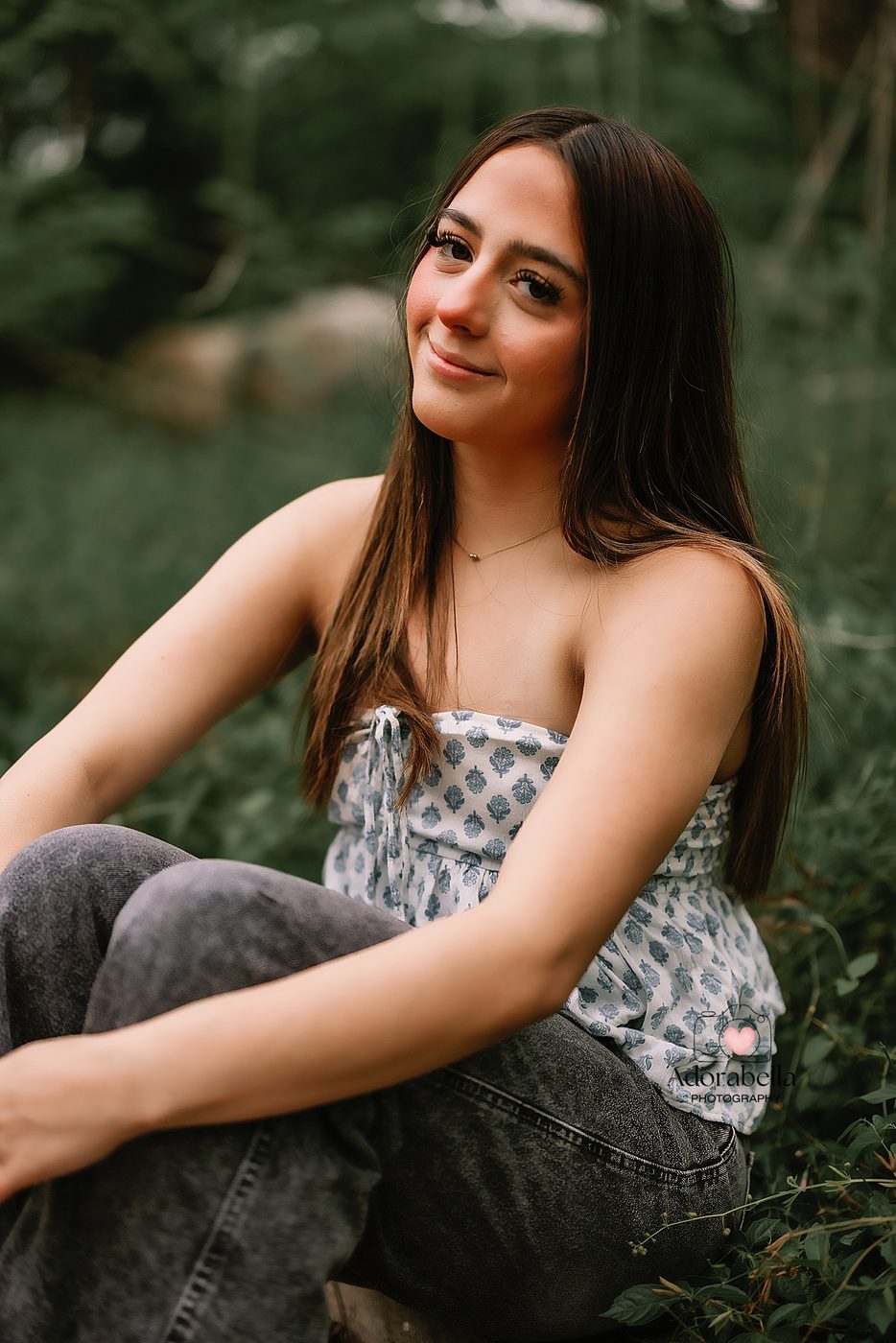 Senior girl seated outdoors in soft evening light