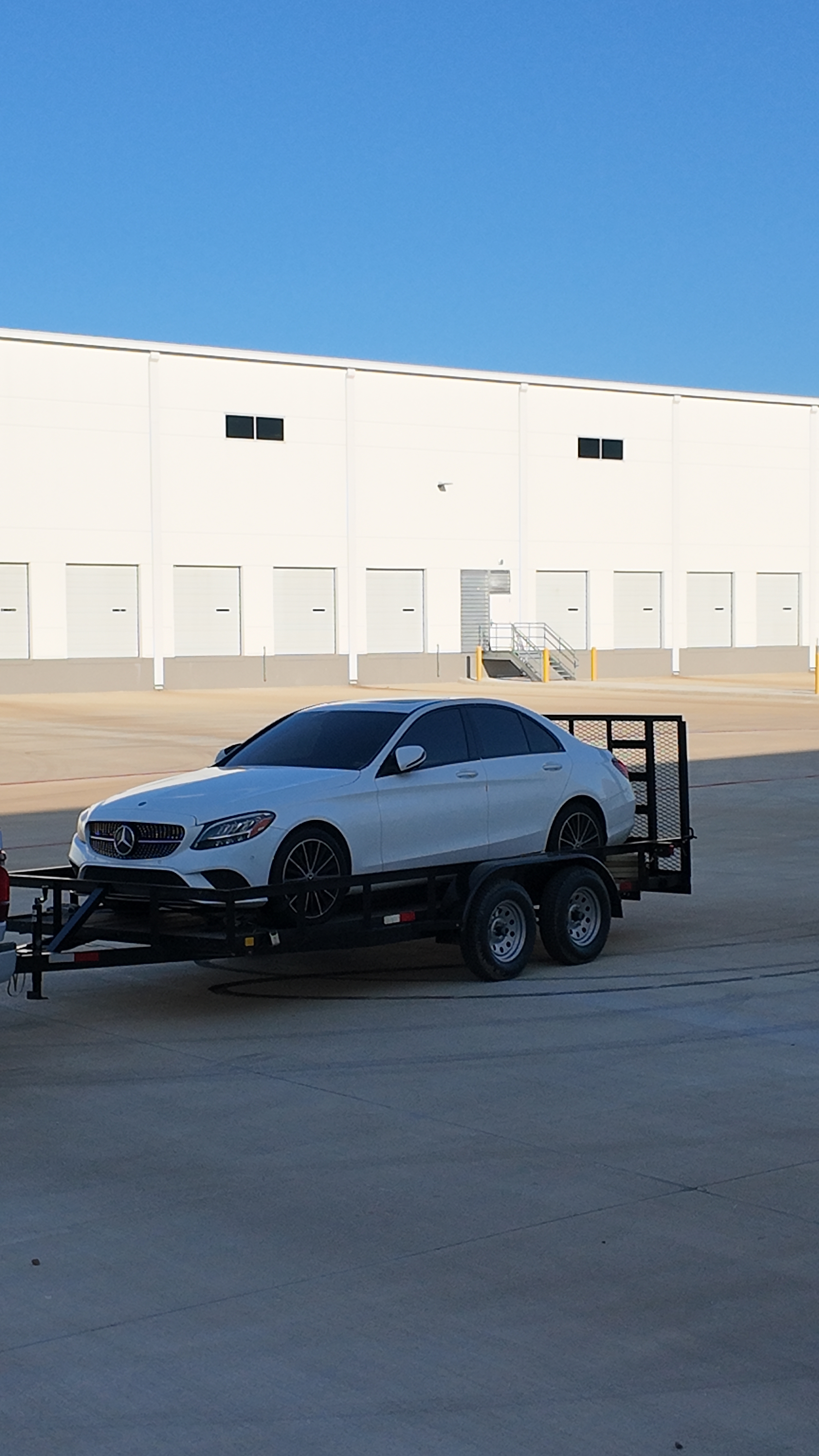 white car over the 16Ft Utility trailer 