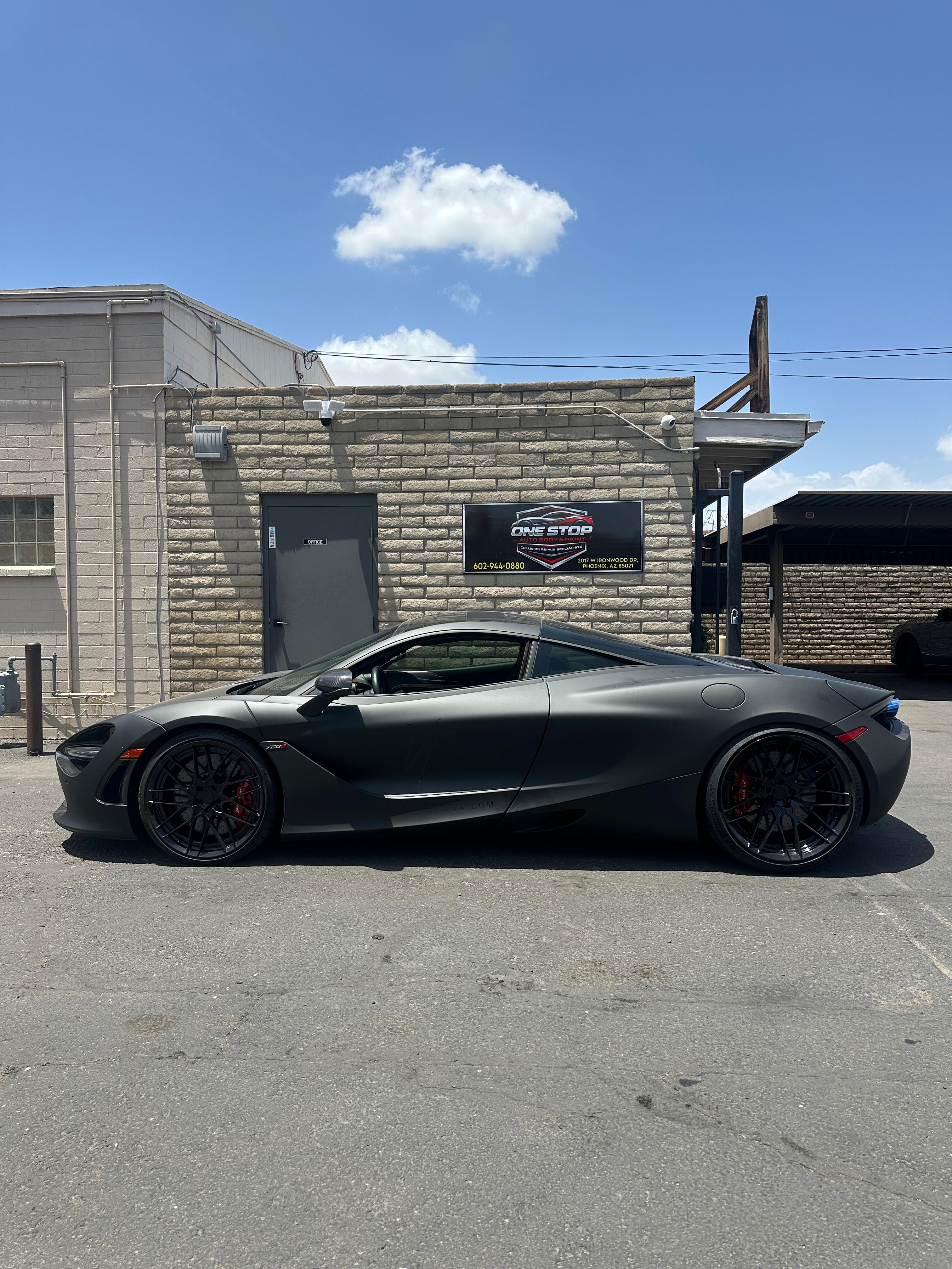 Car in front of One Stop Auto Body shop