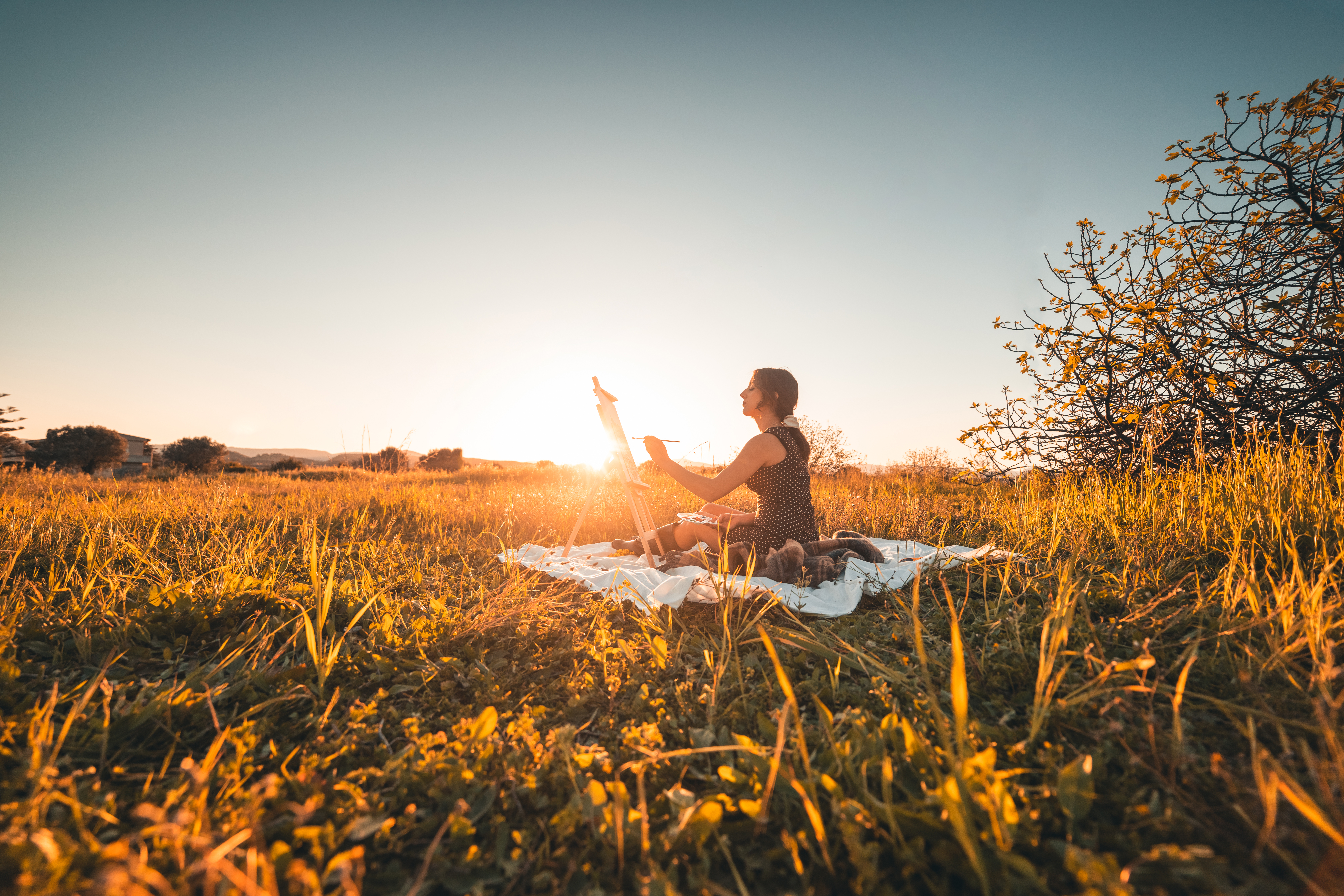 Person in creative flow outdoors at sunrise representing the green world regulated nervous system state of agency and aliveness