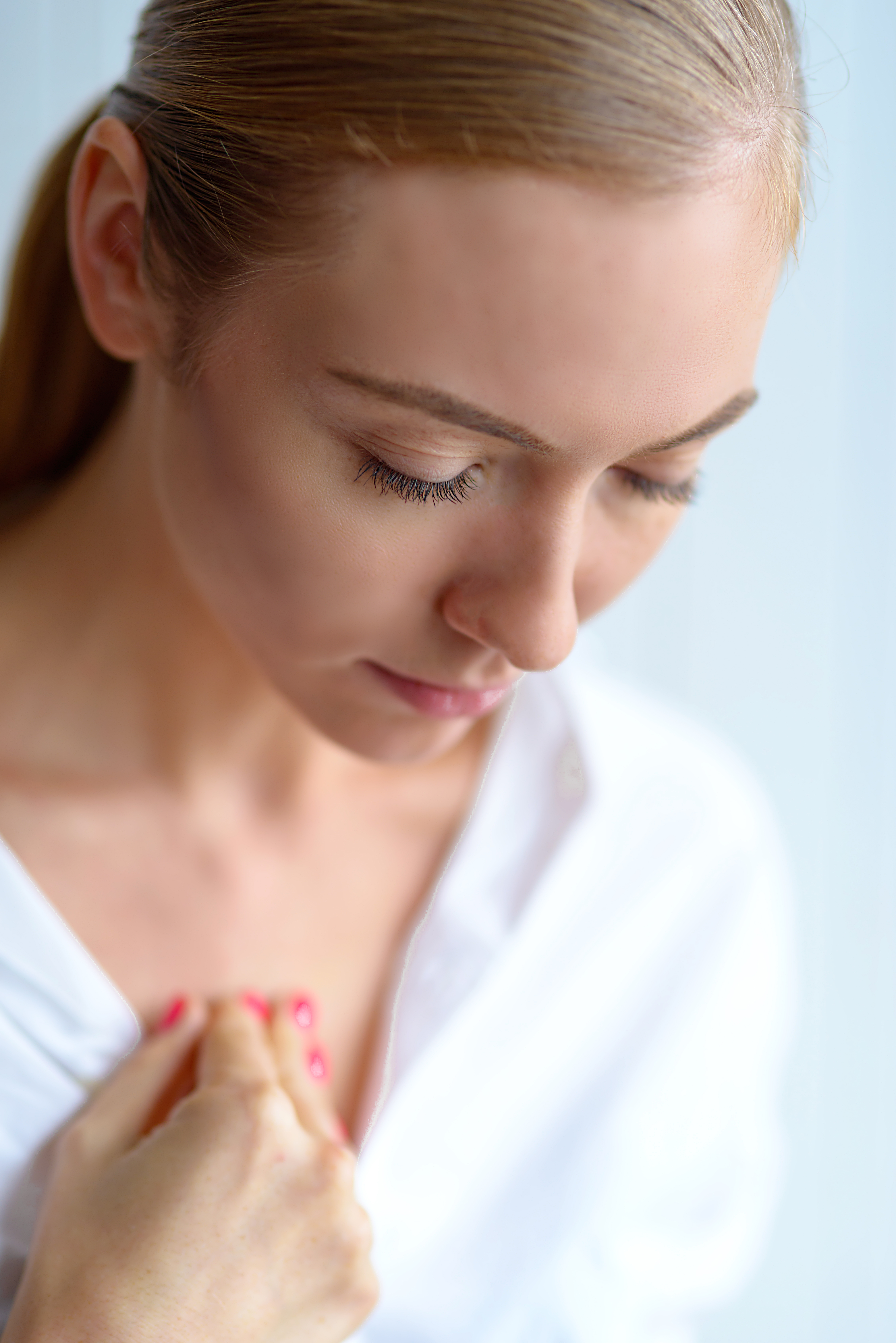 Person tapping on collarbone EFT point for emotional regulation and nervous system support